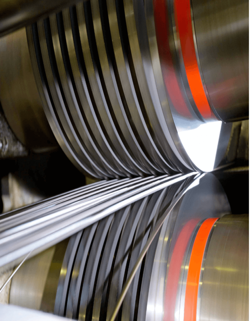 Thermostatic bimetal strip being rolled during the cladding process.